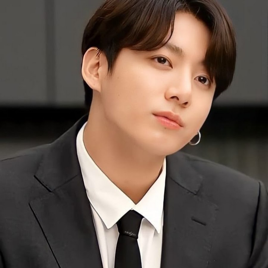 A photo of BTS's Jungkook as a mob boss, in a black suit, in the 