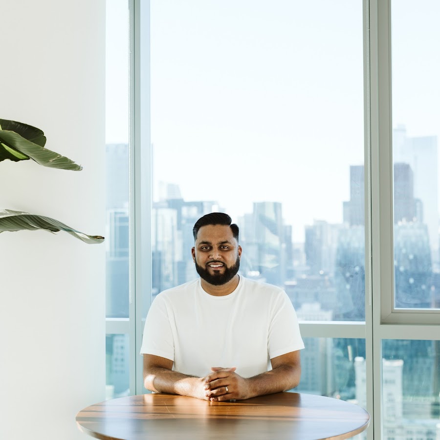 Man sitting beside glass window near high rise building photo