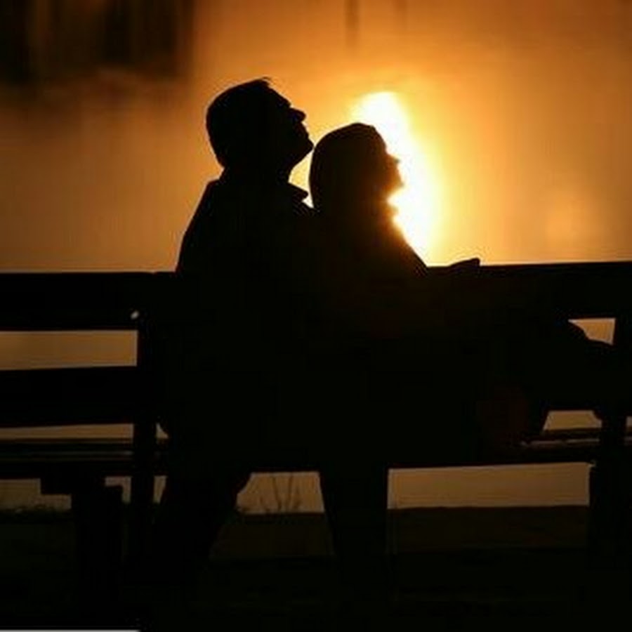 Влюблённая пара на скамейке в темноте